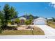 Single-story home with a two-car garage and landscaped yard at 9660 Miami Cir, Port Charlotte, FL 33981