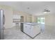 Modern kitchen with island, stainless steel appliances, and view to Gathering room at 9660 Miami Cir, Port Charlotte, FL 33981
