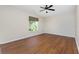 Bright bedroom with hardwood floors and a ceiling fan at 9660 Miami Cir, Port Charlotte, FL 33981