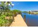 Wooden dock stretches along the canal, providing convenient water access at 9660 Miami Cir, Port Charlotte, FL 33981