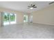 Spacious living room with tile floors and sliding doors to pool area at 9660 Miami Cir, Port Charlotte, FL 33981