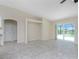 Open living area with tile floors and view of the pool at 9660 Miami Cir, Port Charlotte, FL 33981