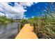 Private dock extends over calm water, offering serene waterfront views at 9660 Miami Cir, Port Charlotte, FL 33981