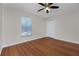 Bright bedroom featuring wood flooring and ceiling fan at 9660 Miami Cir, Port Charlotte, FL 33981