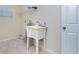 Laundry room with utility sink and shelving at 9660 Miami Cir, Port Charlotte, FL 33981
