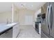 Modern kitchen with stainless steel appliances and blue backsplash at 9660 Miami Cir, Port Charlotte, FL 33981