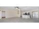 Open living room with high ceiling, tile floors, and kitchen view at 9660 Miami Cir, Port Charlotte, FL 33981