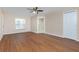 Bright bedroom featuring wood-look laminate floors and a ceiling fan at 9660 Miami Cir, Port Charlotte, FL 33981