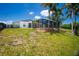 Single-story house with a screened-in patio and a spacious yard at 9660 Miami Cir, Port Charlotte, FL 33981
