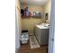 Convenient laundry room with washer, dryer, and shelving at 22216 Midway Blvd, Port Charlotte, FL 33952