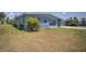 Ranch-style home with light blue exterior and a side view at 22216 Midway Blvd, Port Charlotte, FL 33952