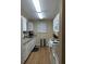 Galley kitchen with white cabinets and granite countertops at 22216 Midway Blvd, Port Charlotte, FL 33952