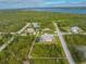 Beautiful aerial view of a property with a screened-in pool, long driveway, and in a peaceful residential neighborhood at 5039 Parker St, Port Charlotte, FL 33981