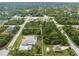 Overhead view of the property nestled in a quiet, residential neighborhood with a screened-in pool and long driveway at 5039 Parker St, Port Charlotte, FL 33981