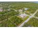An aerial view of the property showing a beautiful home with a screened in pool area and large backyard with lots of greenery at 5039 Parker St, Port Charlotte, FL 33981