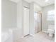 Neutral bathroom featuring a walk in shower, soaking tub, and vanity with lots of space at 5039 Parker St, Port Charlotte, FL 33981