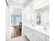 Bright bathroom featuring double sinks, ample storage, and an open doorway to a bedroom at 5039 Parker St, Port Charlotte, FL 33981
