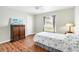 Cozy bedroom featuring hardwood floors, a neutral color scheme, and natural light at 5039 Parker St, Port Charlotte, FL 33981