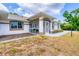 Charming single-story home featuring screened in porch and nicely landscaped front yard at 5039 Parker St, Port Charlotte, FL 33981