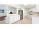 Well-lit kitchen featuring bright white cabinets, a tiled floor, and stainless steel appliances at 5039 Parker St, Port Charlotte, FL 33981