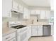 Bright, white kitchen featuring modern appliances, gas range, and ample counter space at 5039 Parker St, Port Charlotte, FL 33981