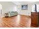 Cozy living room area with hardwood floors, a comfortable sofa, and large windows at 5039 Parker St, Port Charlotte, FL 33981