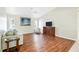 Living room with wood-look floors, large art piece, and comfy seating at 5039 Parker St, Port Charlotte, FL 33981