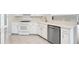 Kitchen boasts white cabinets, stainless steel appliances, and light countertops at 5039 Parker St, Port Charlotte, FL 33981