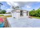 Attached garage with extra storage and a charming exterior at 5039 Parker St, Port Charlotte, FL 33981