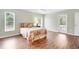 Bedroom with wood-look floors, sliding door to patio, and pool view at 5039 Parker St, Port Charlotte, FL 33981