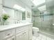 Bright bathroom featuring white cabinetry, a walk-in shower, and updated fixtures at 7486 Palm Island Dr # 2422, Placida, FL 33946
