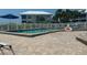 Community pool with brick patio and lounge chairs at 7486 Palm Island Dr # 2422, Placida, FL 33946