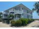Beachfront condo building with white railings and landscaping at 7486 Palm Island Dr # 2422, Placida, FL 33946
