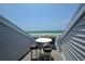 Ocean view balcony with small table and chairs, perfect for relaxing at 7486 Palm Island Dr # 2422, Placida, FL 33946