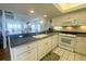 White kitchen with granite countertops and stainless steel appliances at 7486 Palm Island Dr # 2422, Placida, FL 33946