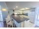 White kitchen with breakfast bar and granite countertops at 7486 Palm Island Dr # 2422, Placida, FL 33946