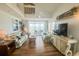 Ocean view living room with comfy sofas, large TV, and hardwood floors at 7486 Palm Island Dr # 2422, Placida, FL 33946