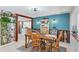 Charming dining room with wooden table and chairs, and accent wall at 150 Sylvania Ave, Englewood, FL 34223