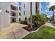 Condo building exterior showcasing entrance and landscaping at 2955 N Beach Rd # A-415, Englewood, FL 34223