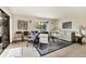 Bright living room with tiled floors, comfortable seating, and access to a patio at 2955 N Beach Rd # A-415, Englewood, FL 34223
