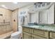 Bathroom includes granite vanity, shower stall, and updated fixtures at 2955 N Beach Rd # A-415, Englewood, FL 34223