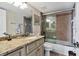 Bathroom features granite vanity, tub/shower combo, and updated fixtures at 2955 N Beach Rd # A-415, Englewood, FL 34223