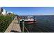 Private boat dock with a red and white boat at 2955 N Beach Rd # A-415, Englewood, FL 34223