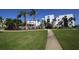 Landscaped walkway leading to the community pool and buildings at 2955 N Beach Rd # A-415, Englewood, FL 34223