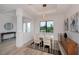 Formal dining room with light wood table and chairs, near the entryway at 10401 Sunday Dr, Port Charlotte, FL 33981