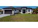 Modern home exterior with a dark gray roof and light-colored walls at 10401 Sunday Dr, Port Charlotte, FL 33981