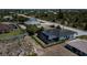 Aerial view showcasing a home with a private pool and surrounding landscape at 10401 Sunday Dr, Port Charlotte, FL 33981