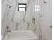 Modern bathroom with marble tile, soaking tub, and shower at 10401 Sunday Dr, Port Charlotte, FL 33981