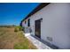Modern house exterior with gray accents and landscaping at 10401 Sunday Dr, Port Charlotte, FL 33981