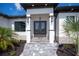 Front entrance with double doors and a stone accent wall at 10401 Sunday Dr, Port Charlotte, FL 33981